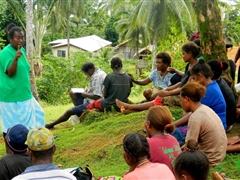 Talking to villagers during public awareness campaign